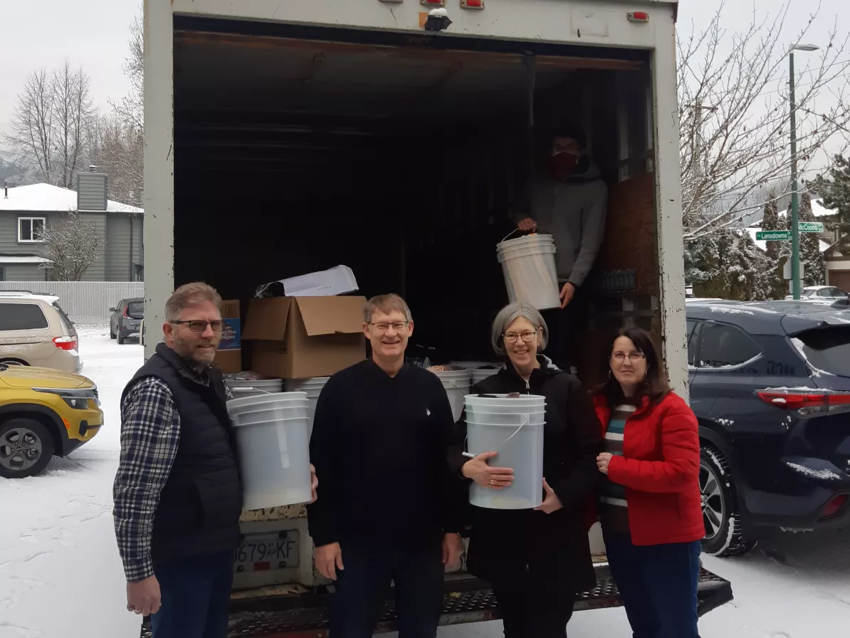 A group of peope loading relief kits into a truck