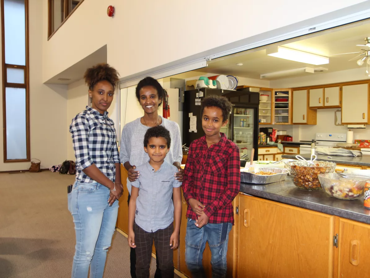 A woman standing with three children