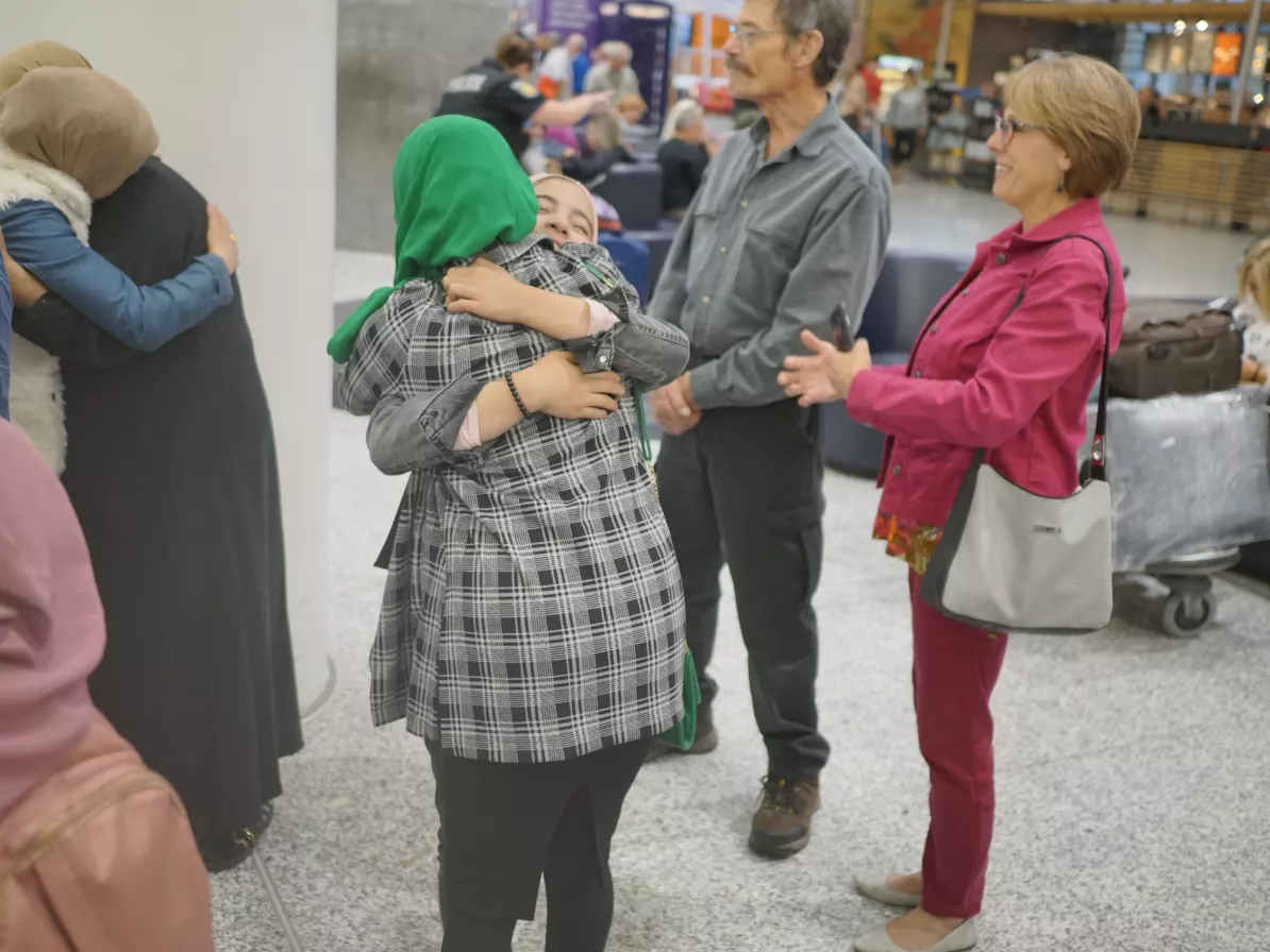 people hugging at airport