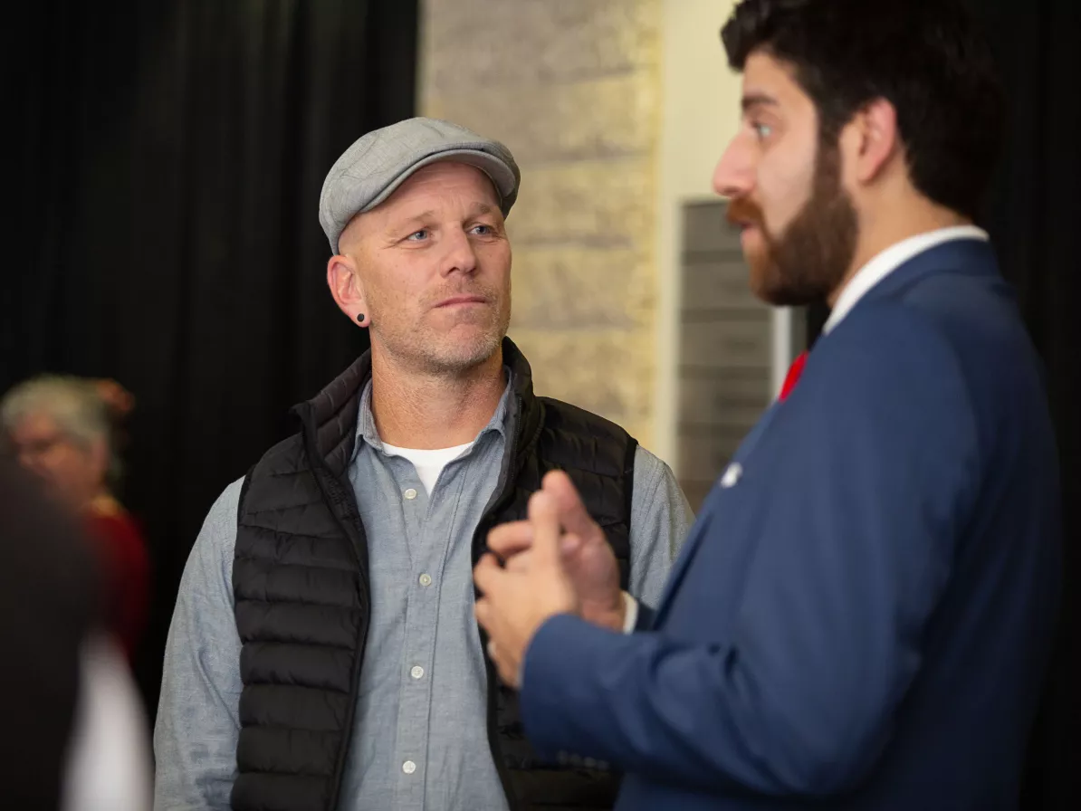 two attendees of a conference in conversation