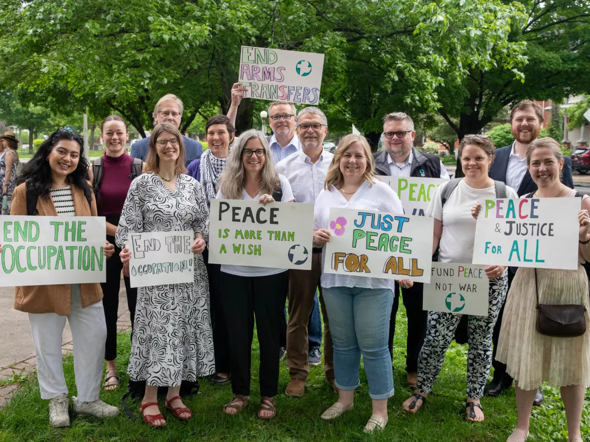 Group of advocates holding signs.