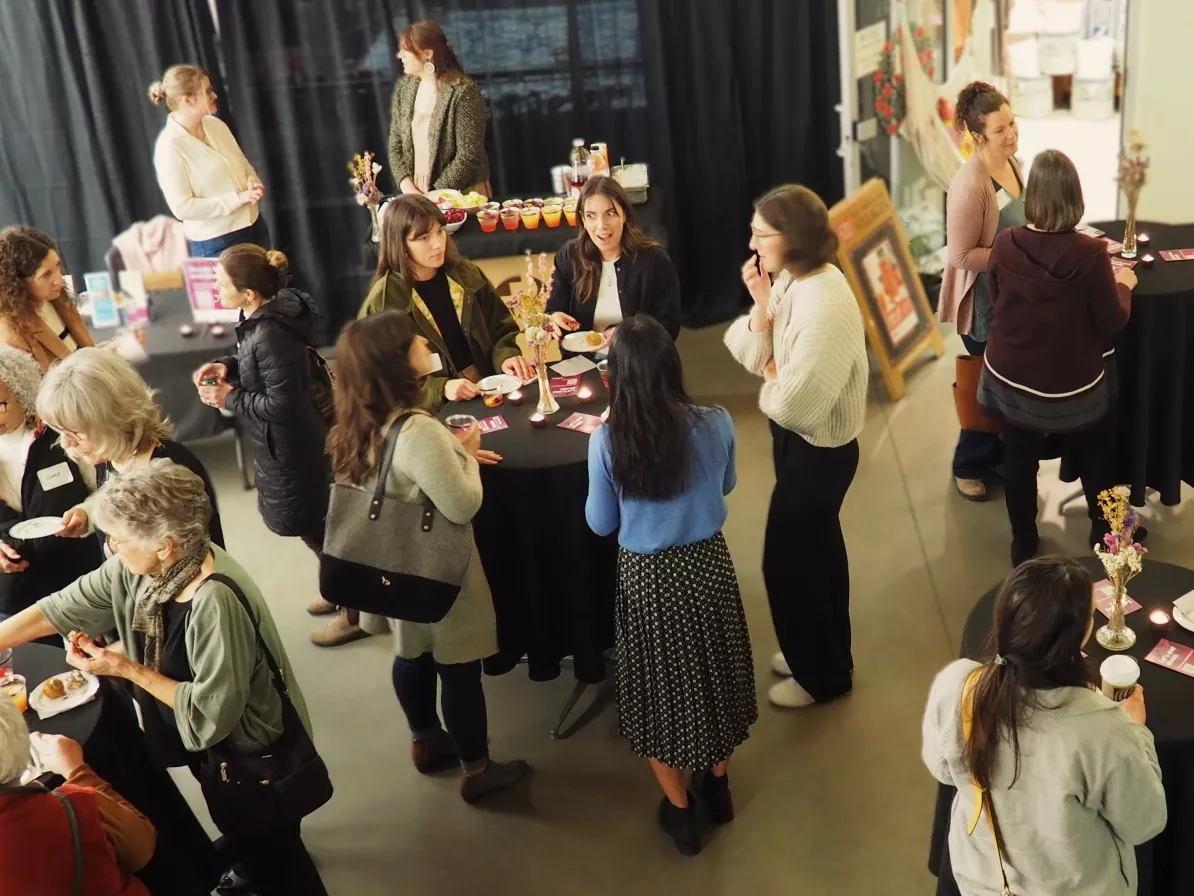 An event with women mingling at tables