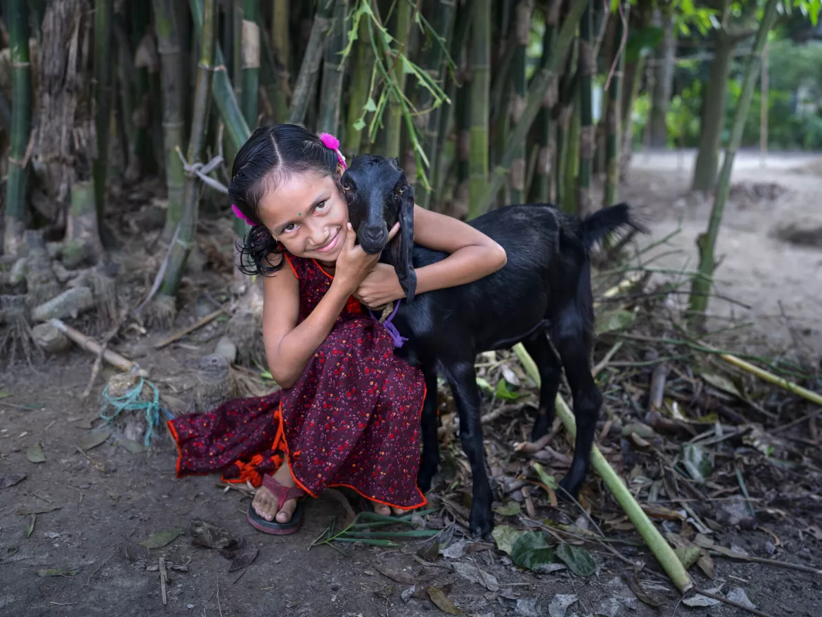 Sangita Sarkar Nodi, 9, is a daughter of a female farmer who uses MPUS “Smart House” techniques at her riverside home. She enjoys the animals her mother raises, especially the goat.