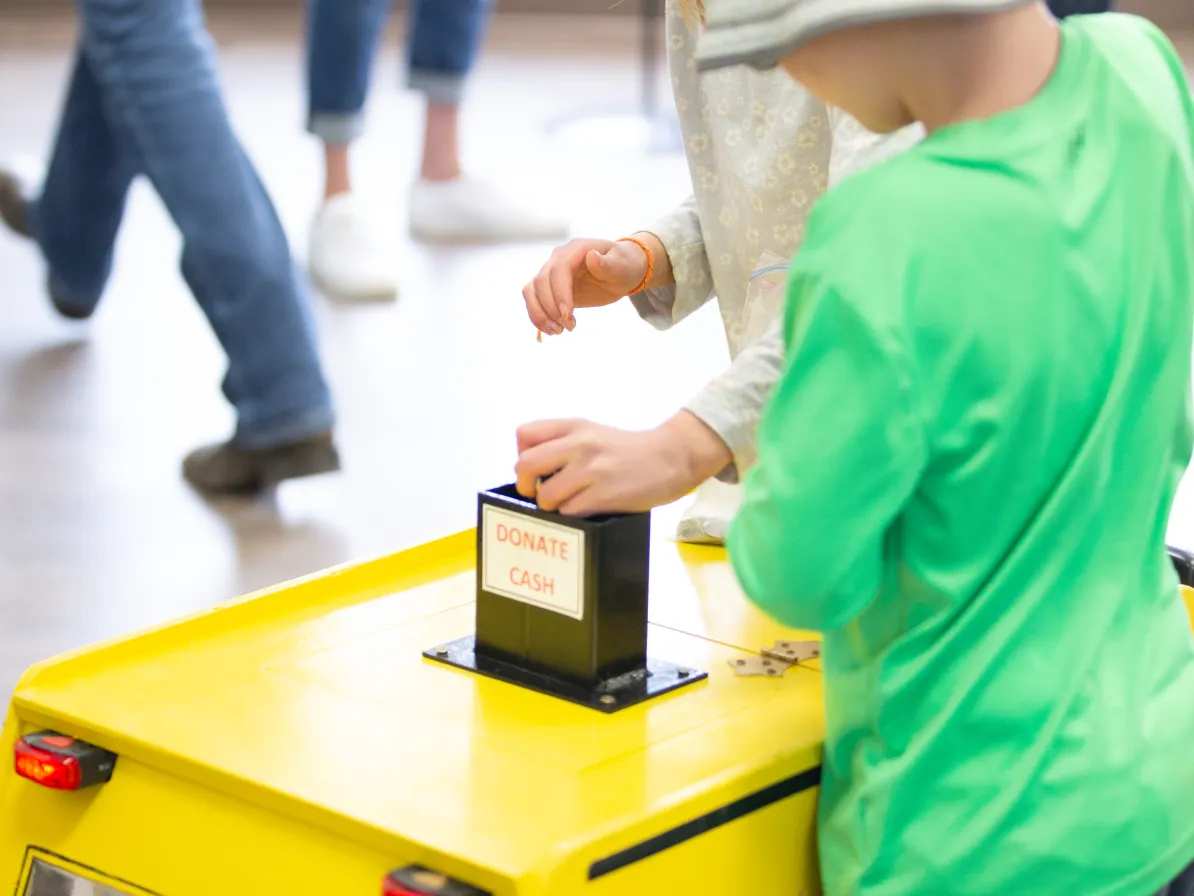 a child collecting coins for the Alberta Relief sale