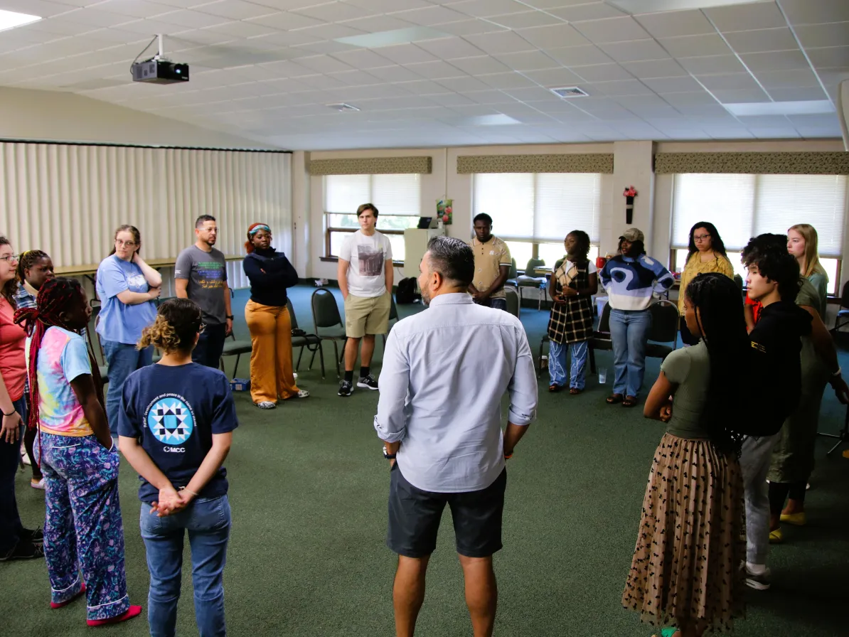 people stand in a circle to talk together