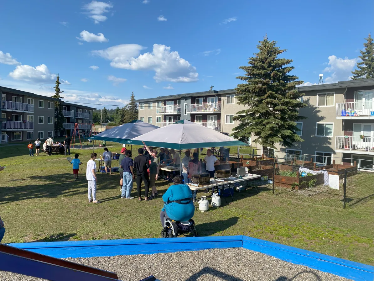An outdoor gathering at the Pineglen apartments in Prince George