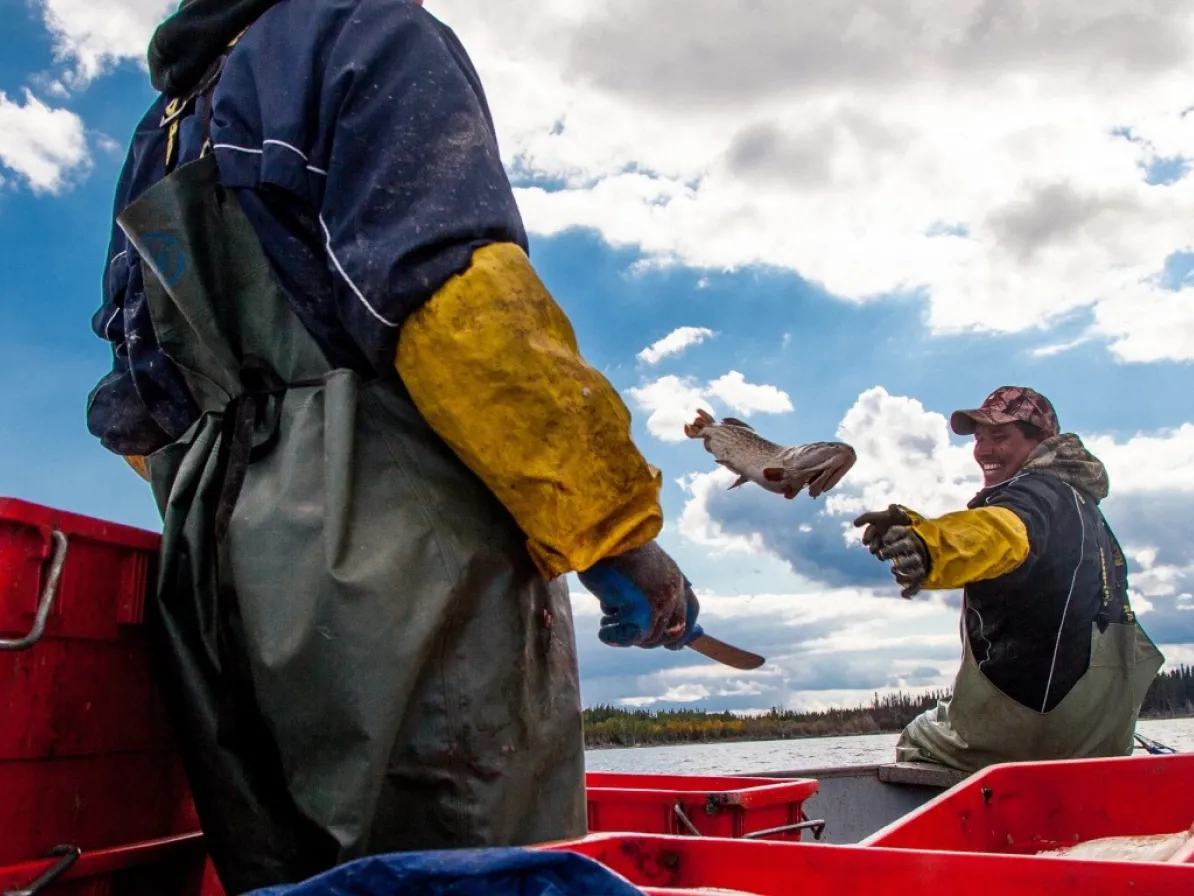 Two people fishing on a lake in Manitoba