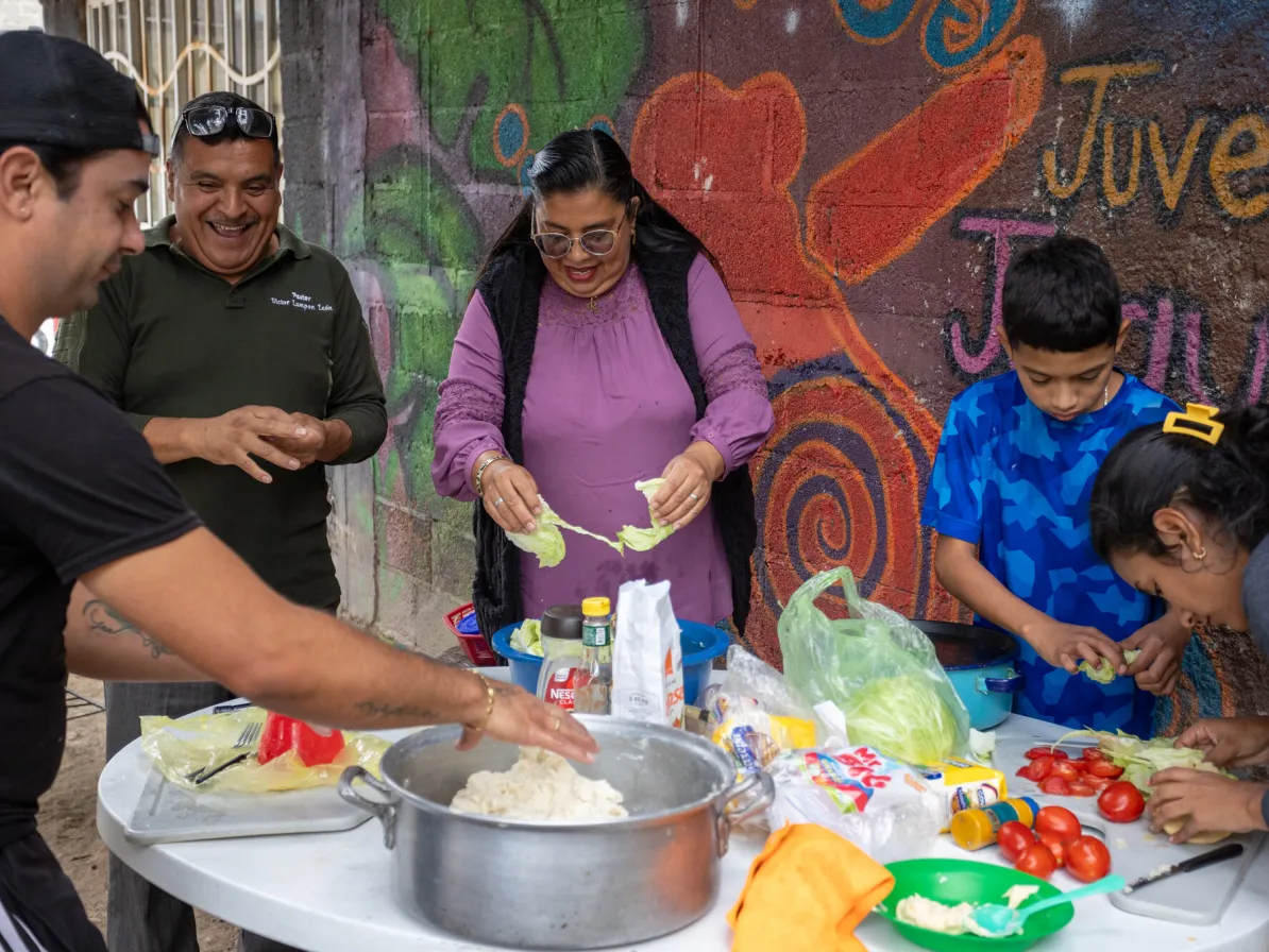 Second from left, pastors Victor Lampón Leon and Rocio Valencia Islas prepare arepas, with migrant* residents at La Mano de Dios en Apoyo al Migrante (God’s Hand in Support of Migrants) in Cuauht