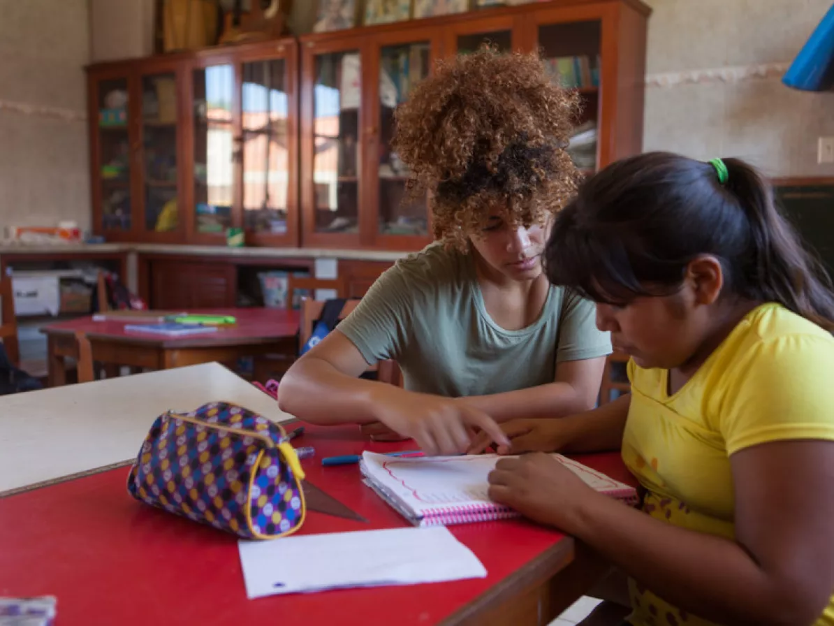 Joia McManus SALTer from Philadelphia helps Maria Elena Zurita Garcias (11) with homework at El Comedor de Niños, in Montero, Bolivia.The Comedor is more than an after-school centre for children in th