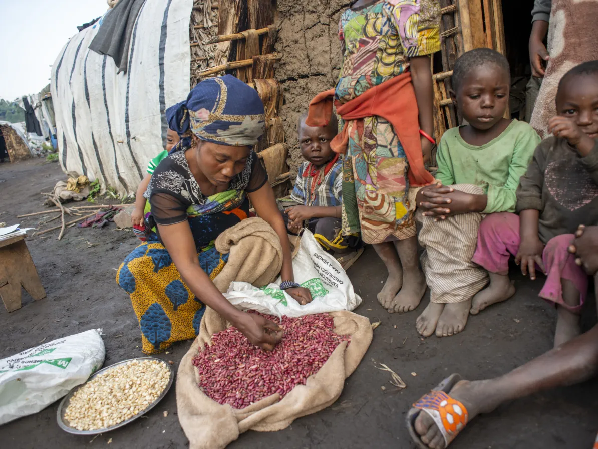 Nsimire Mugoli sorts beans she just received at an emergency food ration earlier in the day. 
At Mubimbi camp near the town of Minova, South Kivu Province, the Democratic Republic of the Congo (DR Co