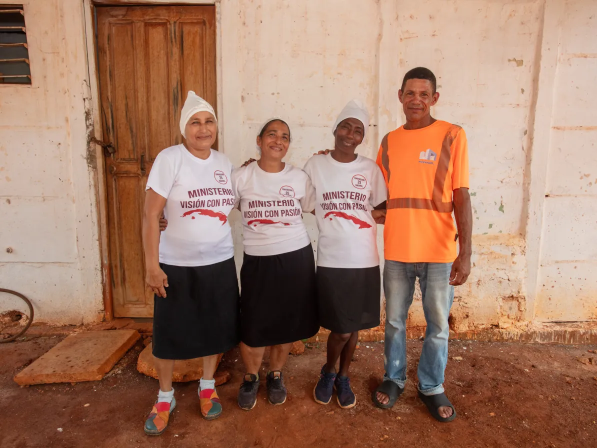 Members, left to right, Milvian Reyes Reyes, Lizet Cordero Gonzales and Noralvis Reve Ravelo stand with Pastor Carlos Marcos Vega Velázquez at Iglesia Confesión de Fe (Confession of Faith Church) in