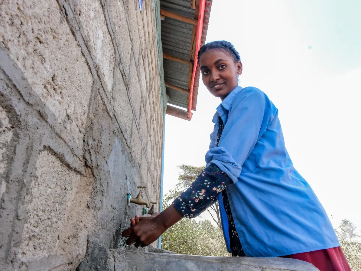 8th grade students Mihret Daba washes her hands at water taps funded by MCC at Ajiti Primary School in Batu, Ethiopia. March, 2024