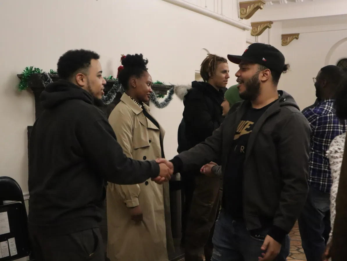 Participants in the week-long "Peace for the Weary" camp for young adults, held at Camp Deerpark in Westbrookville, New York, engage in a conversation circle during a debrief and closing activity at a