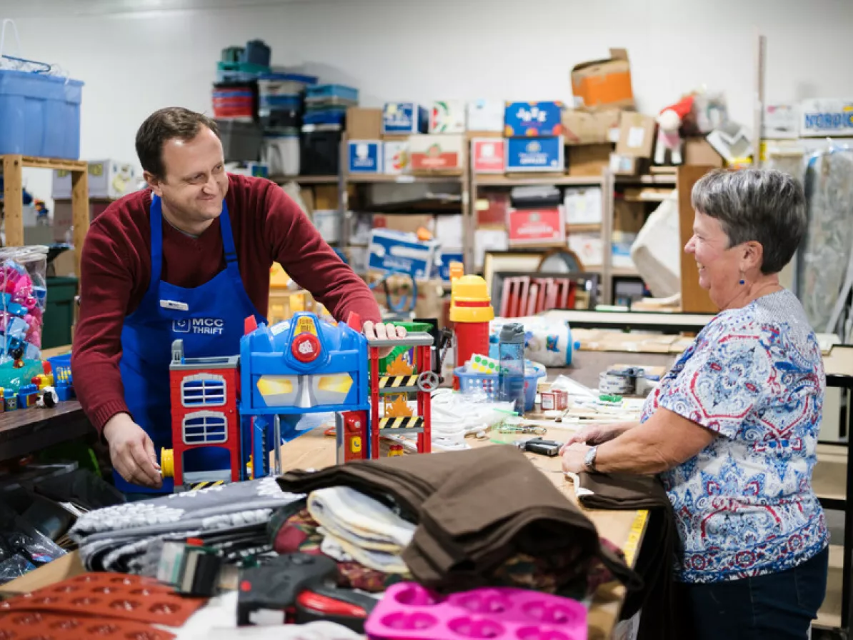 Thrift volunteers Alexander Germann (left) and Janice Wiggins (right) make sure a children's toy donation is in good working order before putting it out on the shop floor.