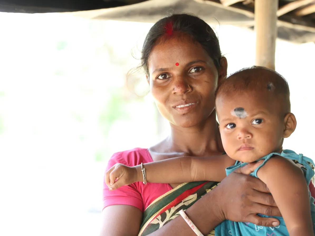 Monika Tudu, 27, holds her  2-year-old daughter, Jyoti Kisku.