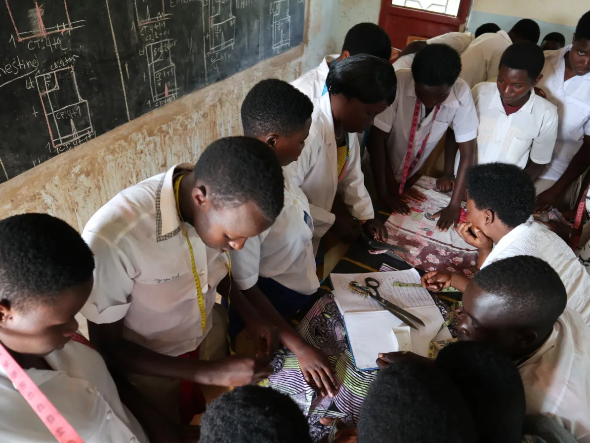 Students are learning to make accurate measurements during tailoring class at Mwana Nshuti Vocational Training Center, Bugesera campus.