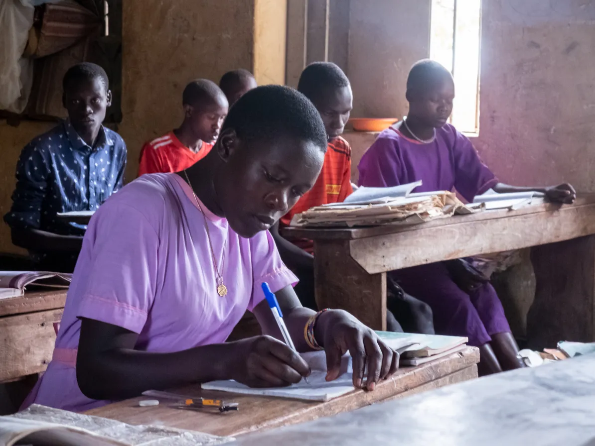 Nicolina Napeyok (purple), age 16, in the P7 class  at Lokwakaromoe II Primary School in Lokwakaromoe, Uganda.