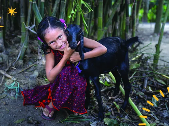 A girl embracing a goat.