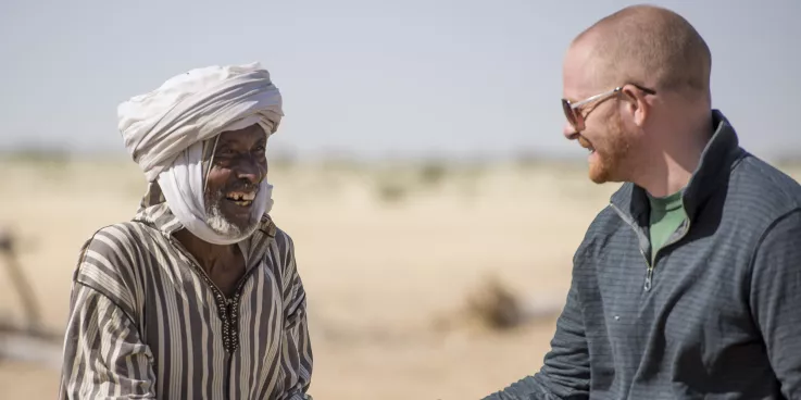 Mr. Ngueni (uses one name) shakes hands with Jonathan Austin, MCC representative for Chad, during a MCC staff visit to the North Kanem region of Chad in 2015.