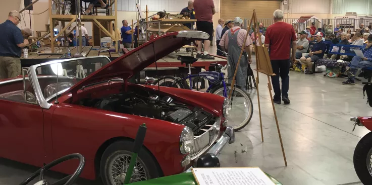 Vintage cars in front of auction stage