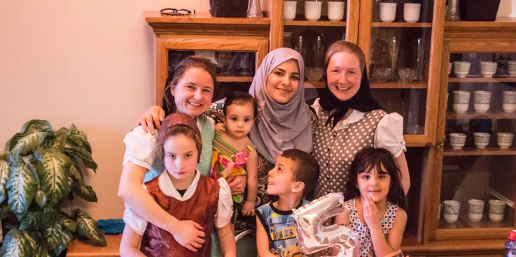 a family of Hutterites with a family of refugees