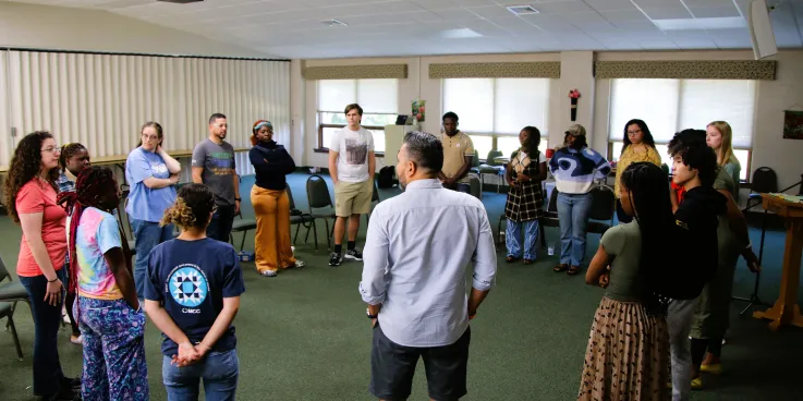 people stand in a circle to talk together