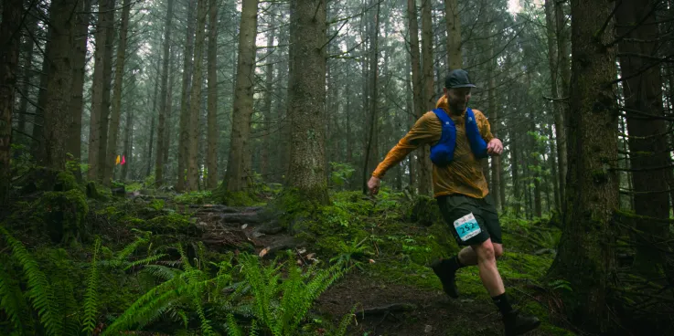 Man running through a forest