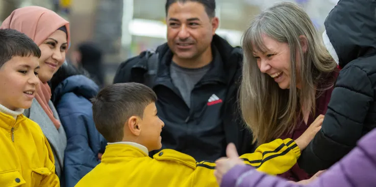 A family greeting friends at the airport