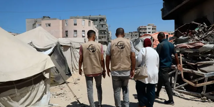 A group of people walking amidst destruction