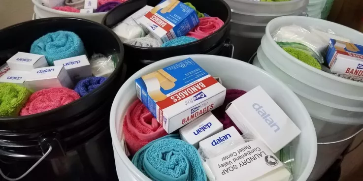 Relief kits await lids at the Material Resources Center in Ephrata, PA. Relief kits include:

	
		4 large bars bath soap 
	
		1 plastic bottle shampoo (13–24 oz; place in resealable plastic bag)