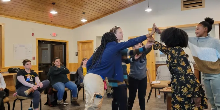 Participants in the week-long "Peace for the weary" camp for young adults held at Camp Deerpark in January build a symbol of reconciliation representing truth, mercy, peace and justice. Pictured from