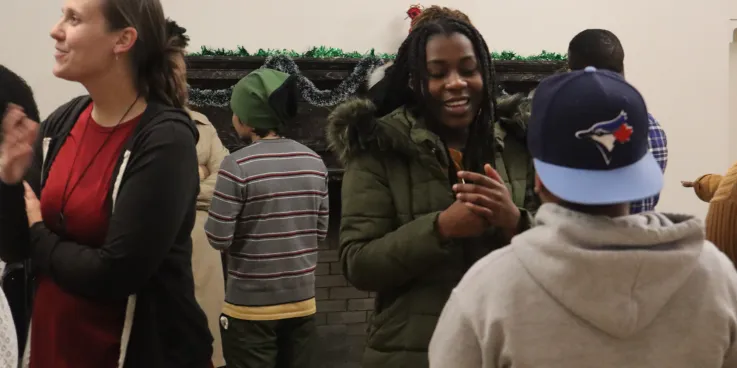 Participants in the week-long "Peace for the Weary" camp for young adults, held at Camp Deerpark in Westbrookville, New York, engage in a conversation circle during a debrief and closing activity at a