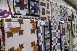 Several quilts on display at an auction