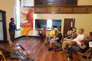 women stands and speaks to a group