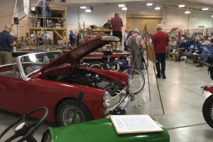 Vintage cars in front of auction stage