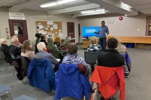 A man delivers a seminar to a small group of people