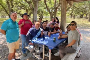 Group of people sit around a table. 