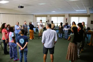 people stand in a circle to talk together