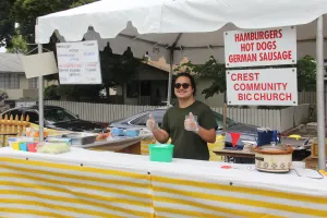 a male standing in front of a food stand