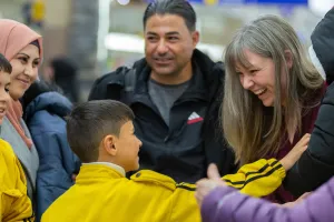 A family greeting friends at the airport
