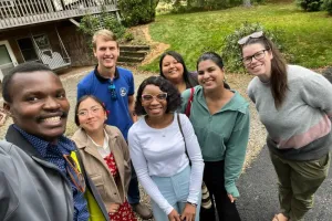 A group of people gather for a selfie. 
