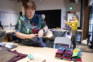 Two women pack dignity kits at a packing event in Manitoba