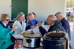 People gathered around a table, eating together. 