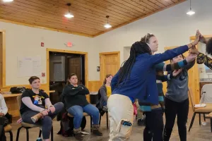 Participants in the week-long "Peace for the weary" camp for young adults held at Camp Deerpark in January build a symbol of reconciliation representing truth, mercy, peace and justice. Pictured from