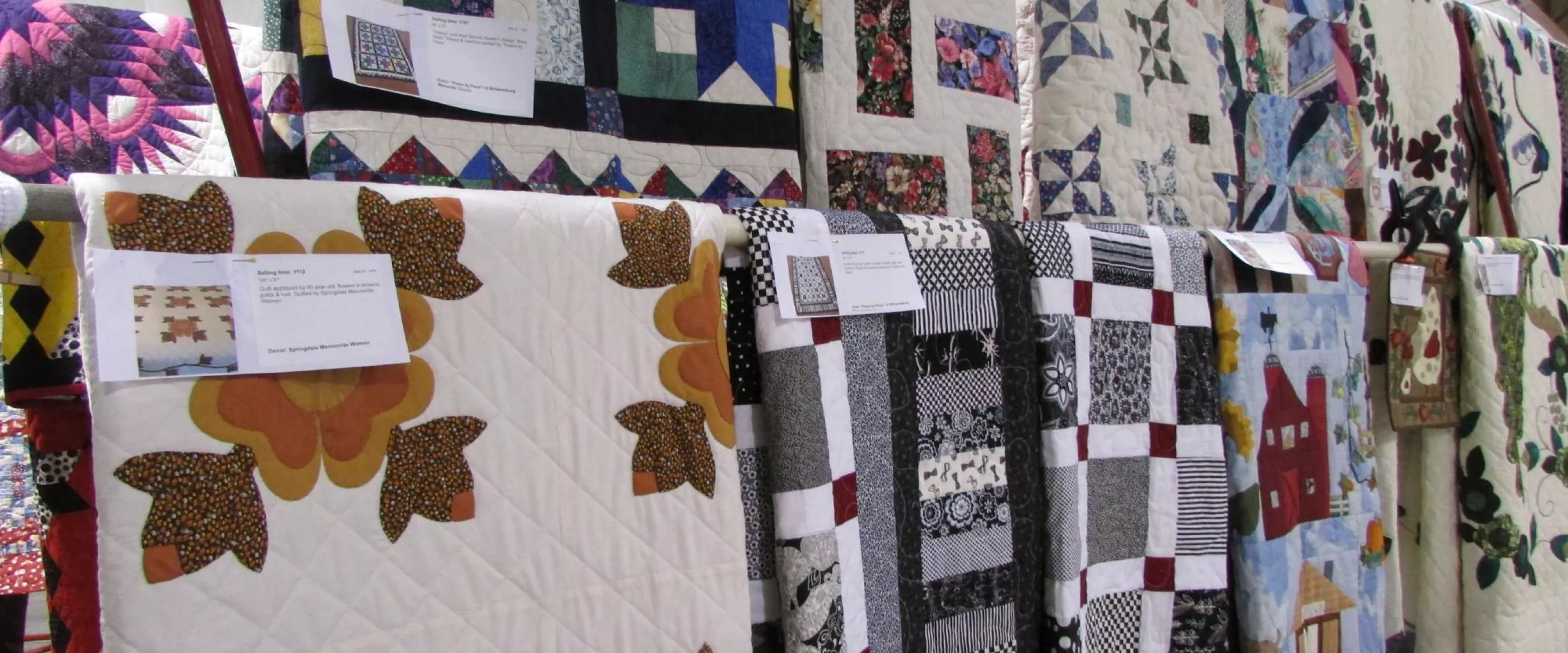 Several quilts on display at an auction