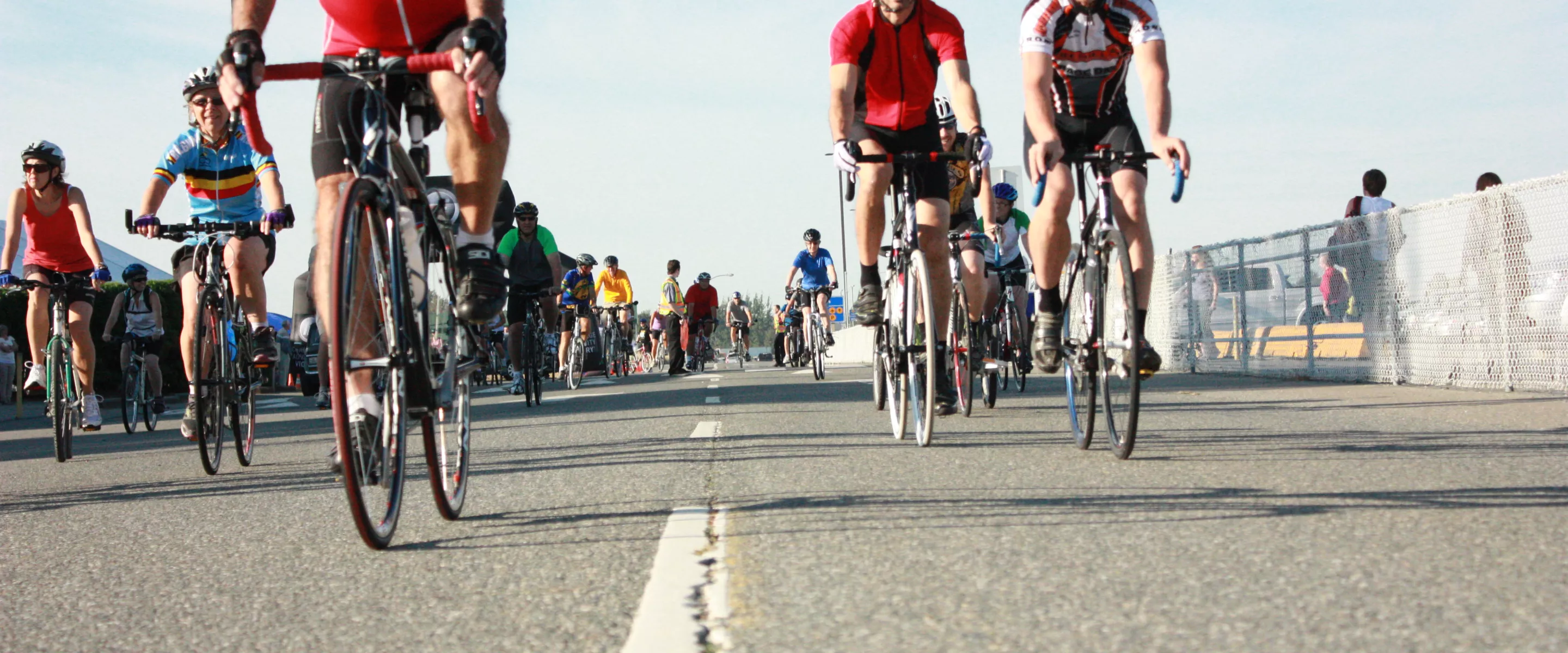A group of cyclists bicycling toward the camera lens.