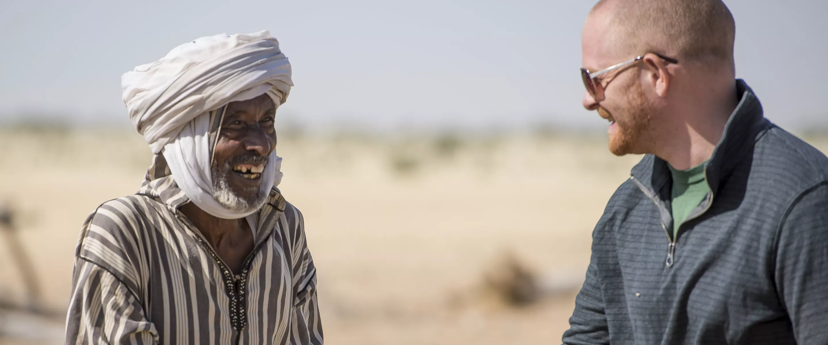 Mr. Ngueni (uses one name) shakes hands with Jonathan Austin, MCC representative for Chad, during a MCC staff visit to the North Kanem region of Chad in 2015.