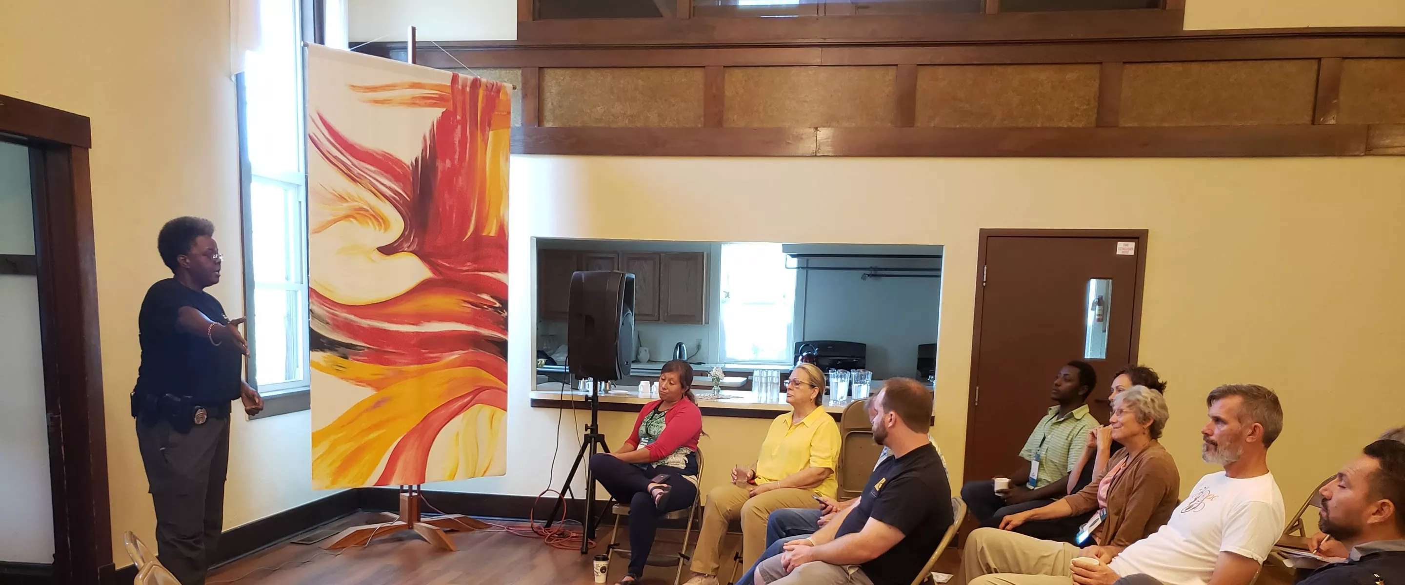 women stands and speaks to a group