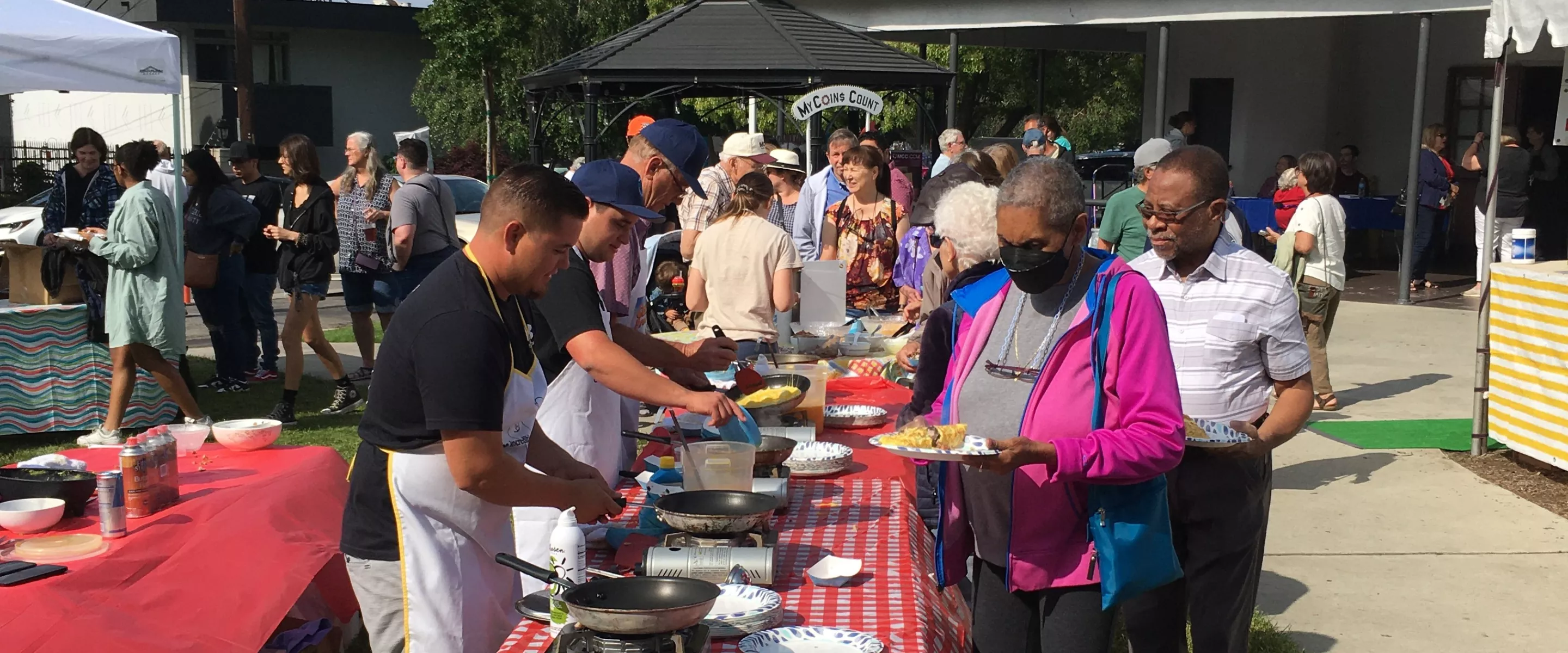 People lining up to get omelets for breakfast.