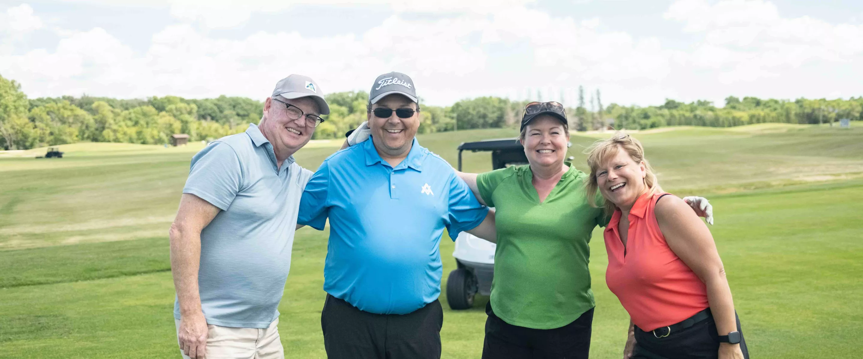 four people on golf green